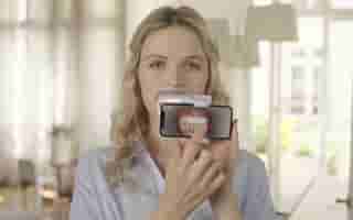 An adult man smiles in an orthodontics office