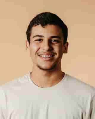 A happy teenage boy with brcaes